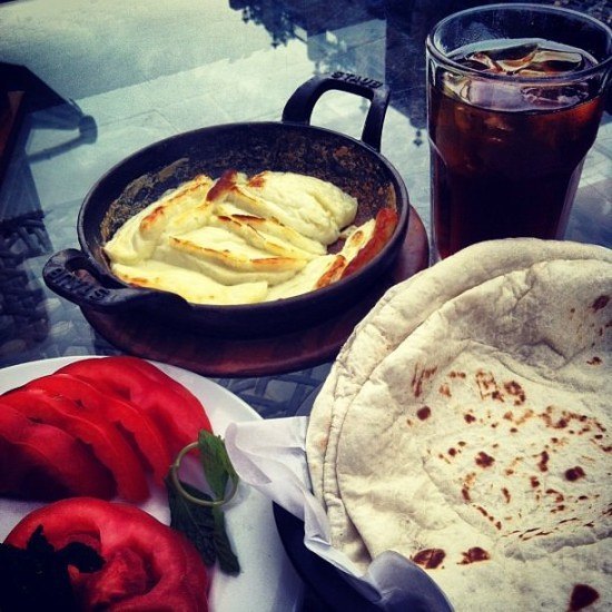 Arabic break, baked halloumi and fresh tomatoes with a side of ice tea. My Doha kind of meal!